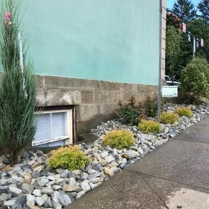 Commercial rock bed with ornamental shrubs